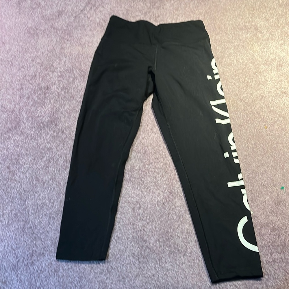 Black workout leggings with CK decal on right leg